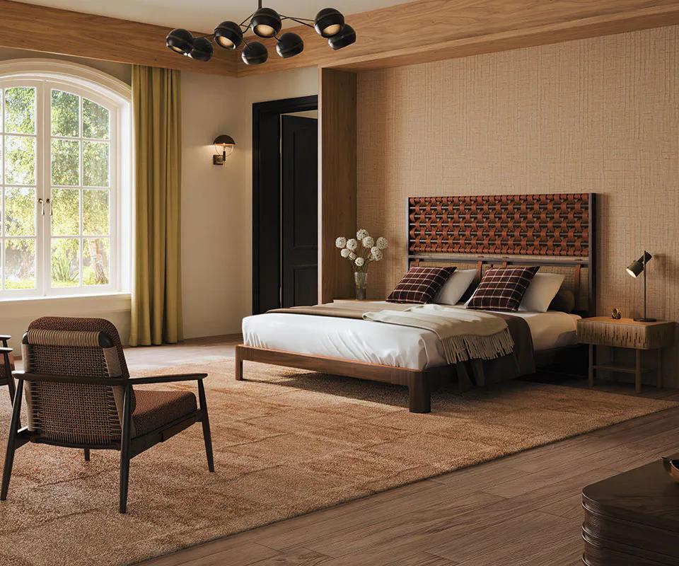 Bedroom with a woven headboard, linen bedding and a sculptural chandelier