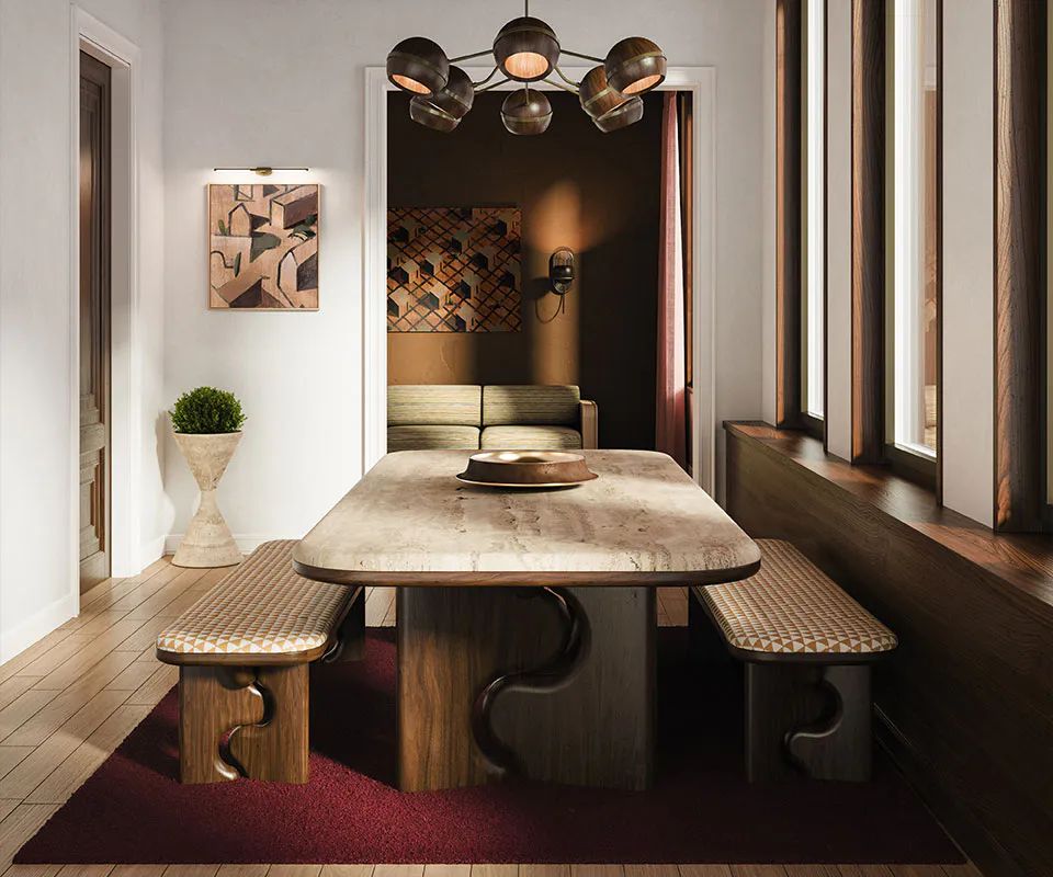 Stone dining table with upholstered benches in warm evening light
